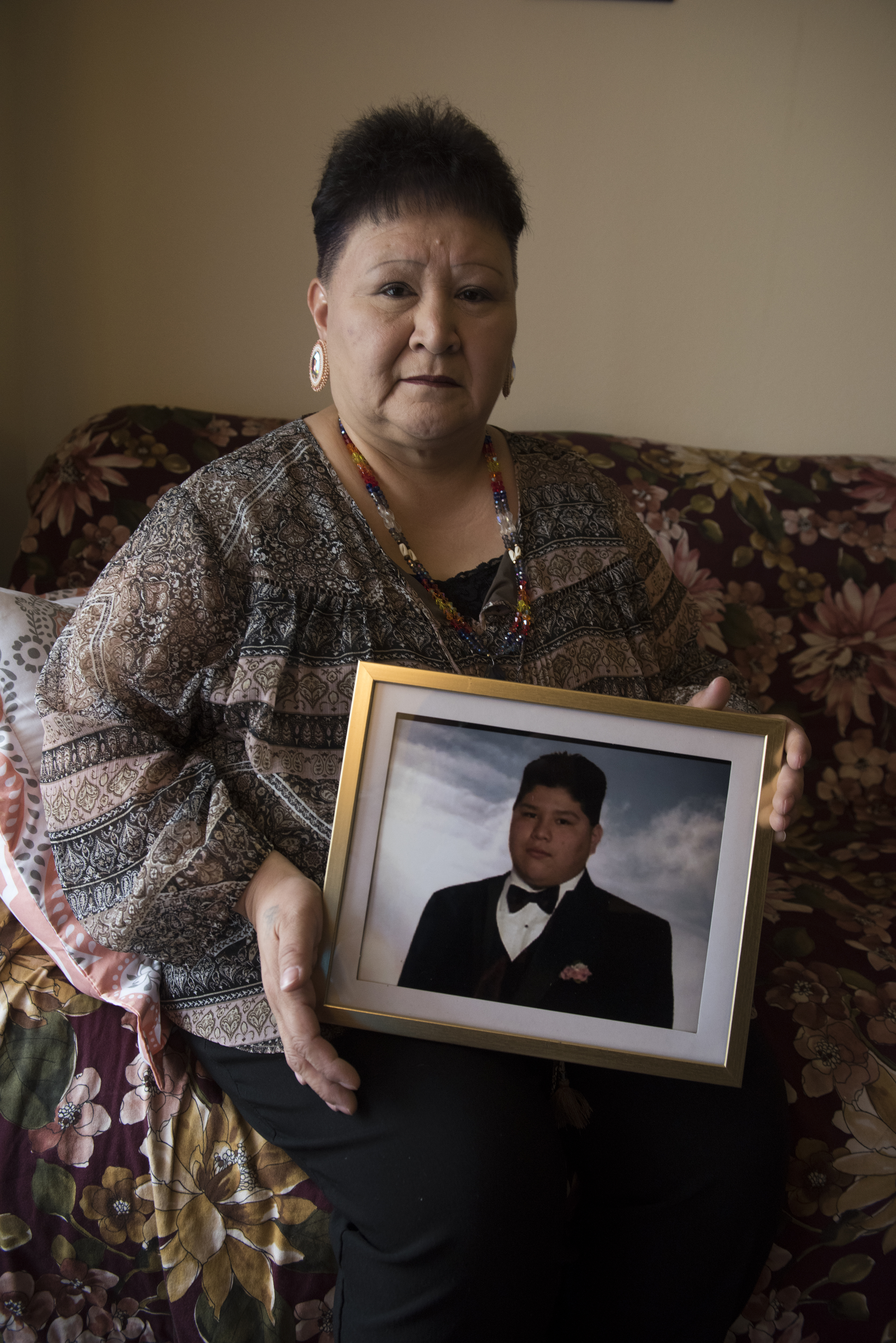 Willeena George holds a prom photo of her son Domonique Nappo