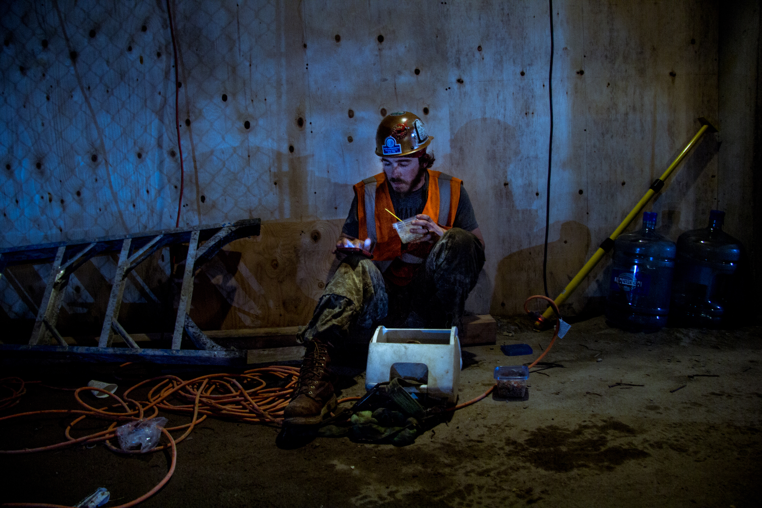 Outside a “lunch shack” on the underground floor of a large downtown development, Gregory Warren is eating a carefully packed lunch.