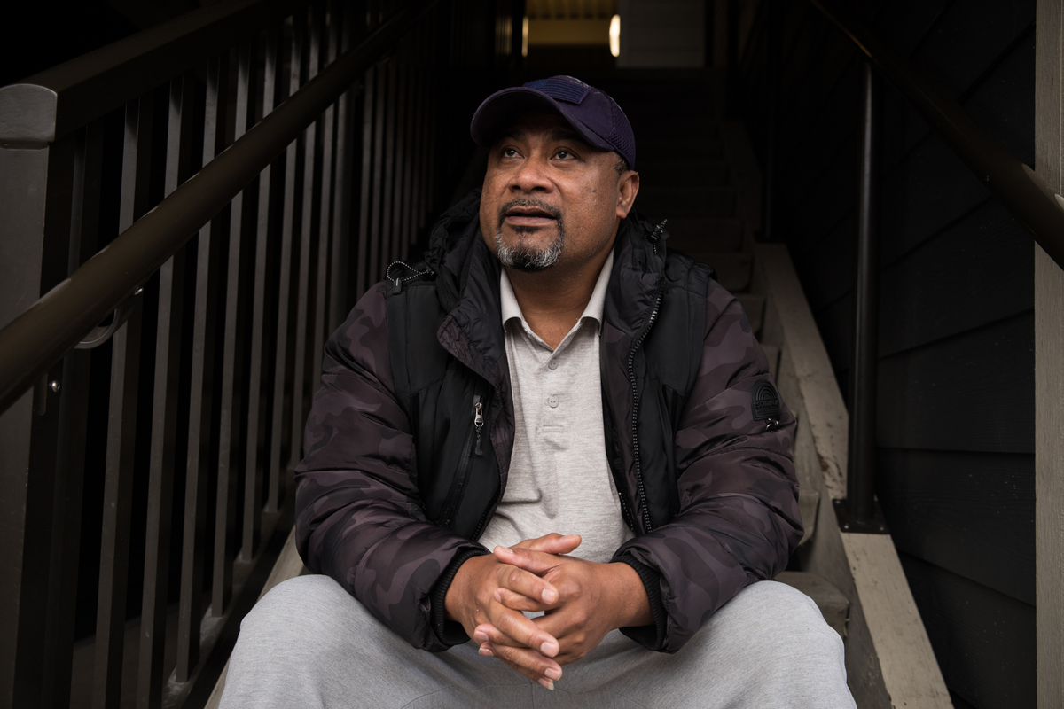 James Kally sits on the steps of his apartment building