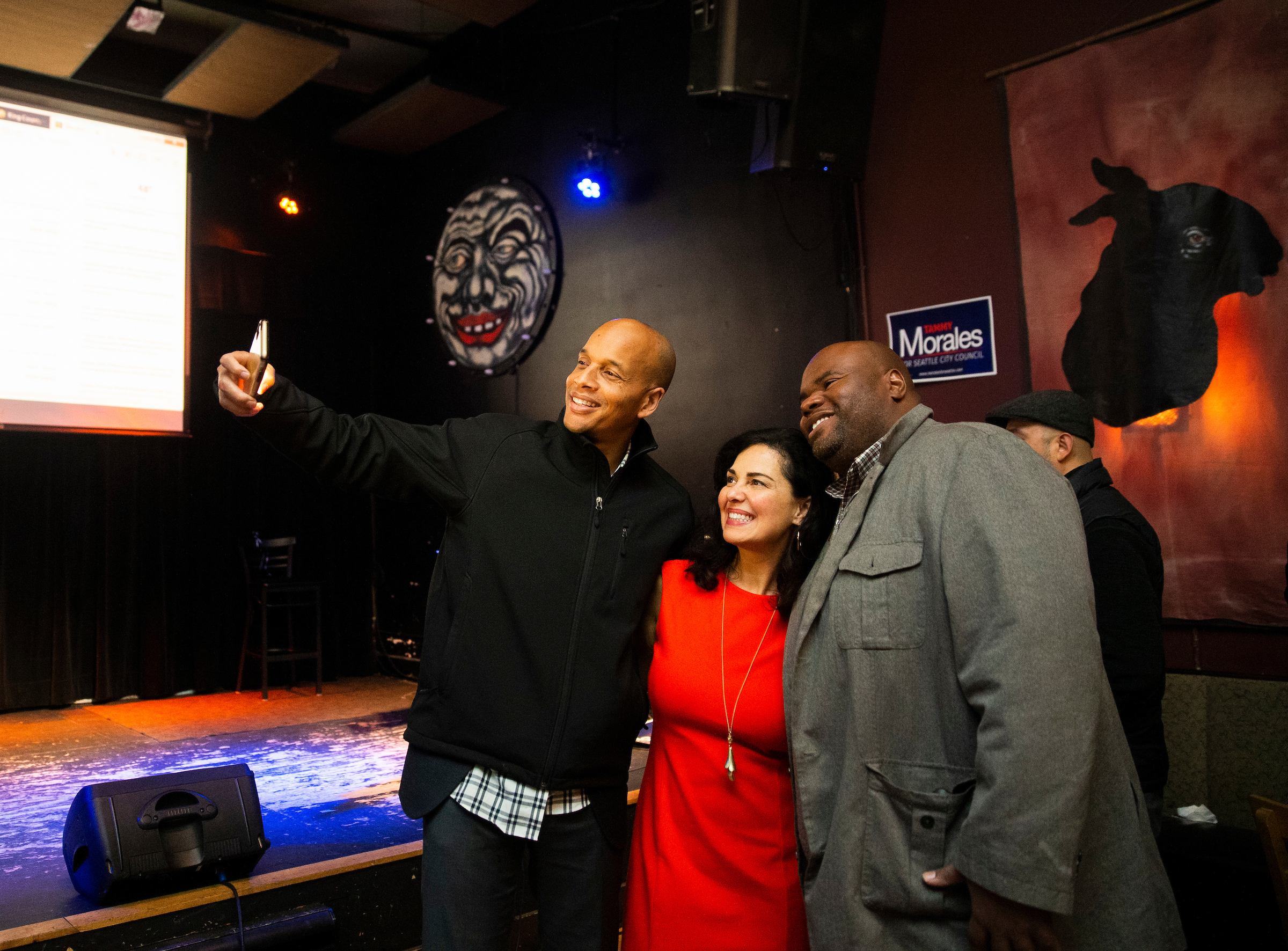 Morales poses for a selfie with guests