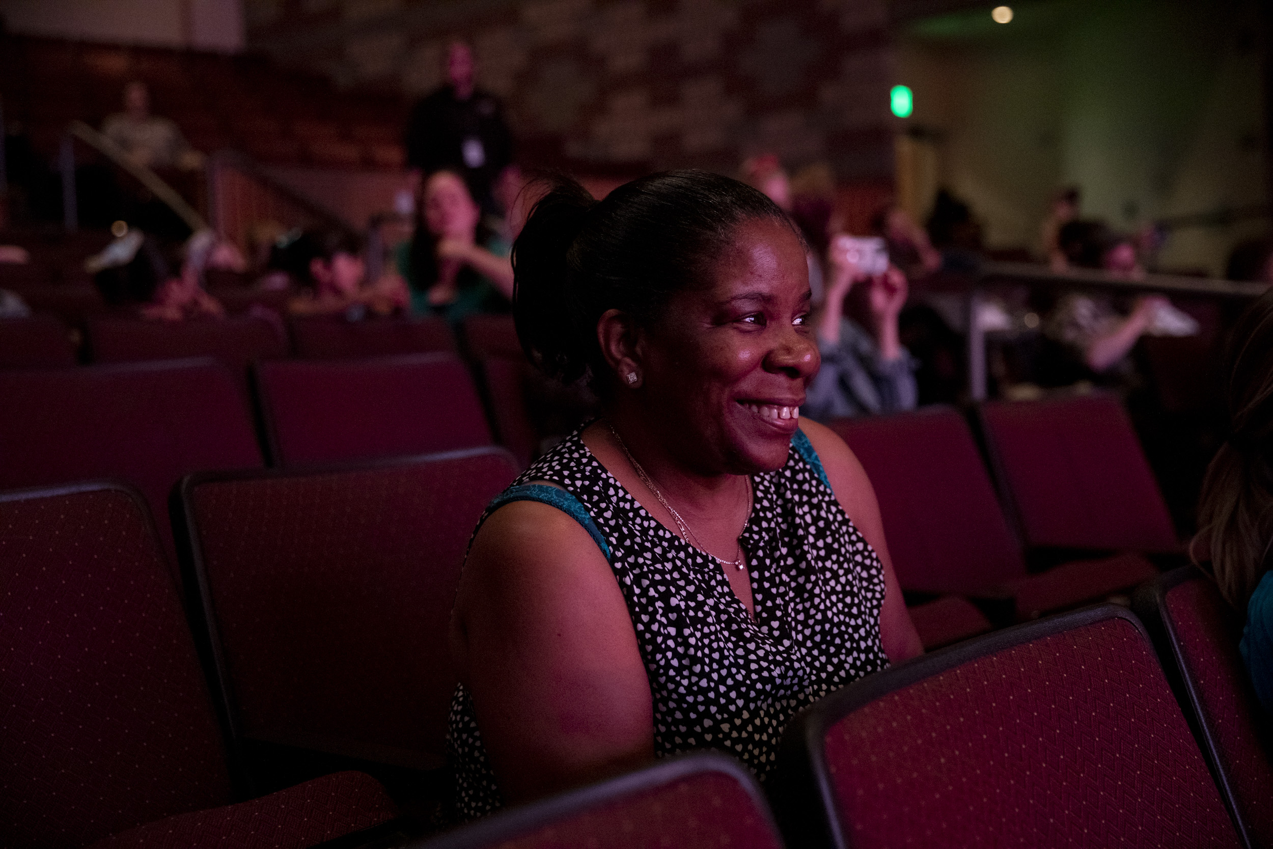 Alesia watches the stage from the audience