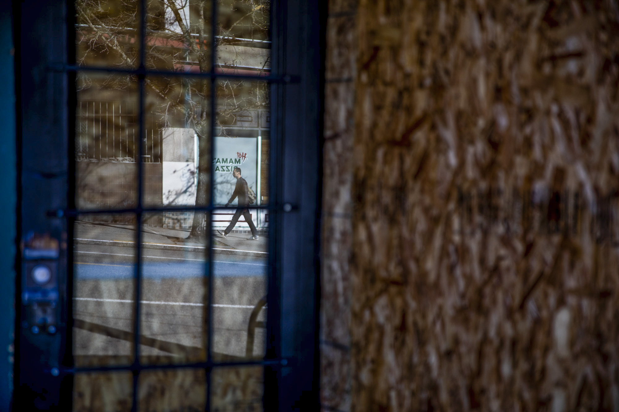 Reflection of man on the sidewalk