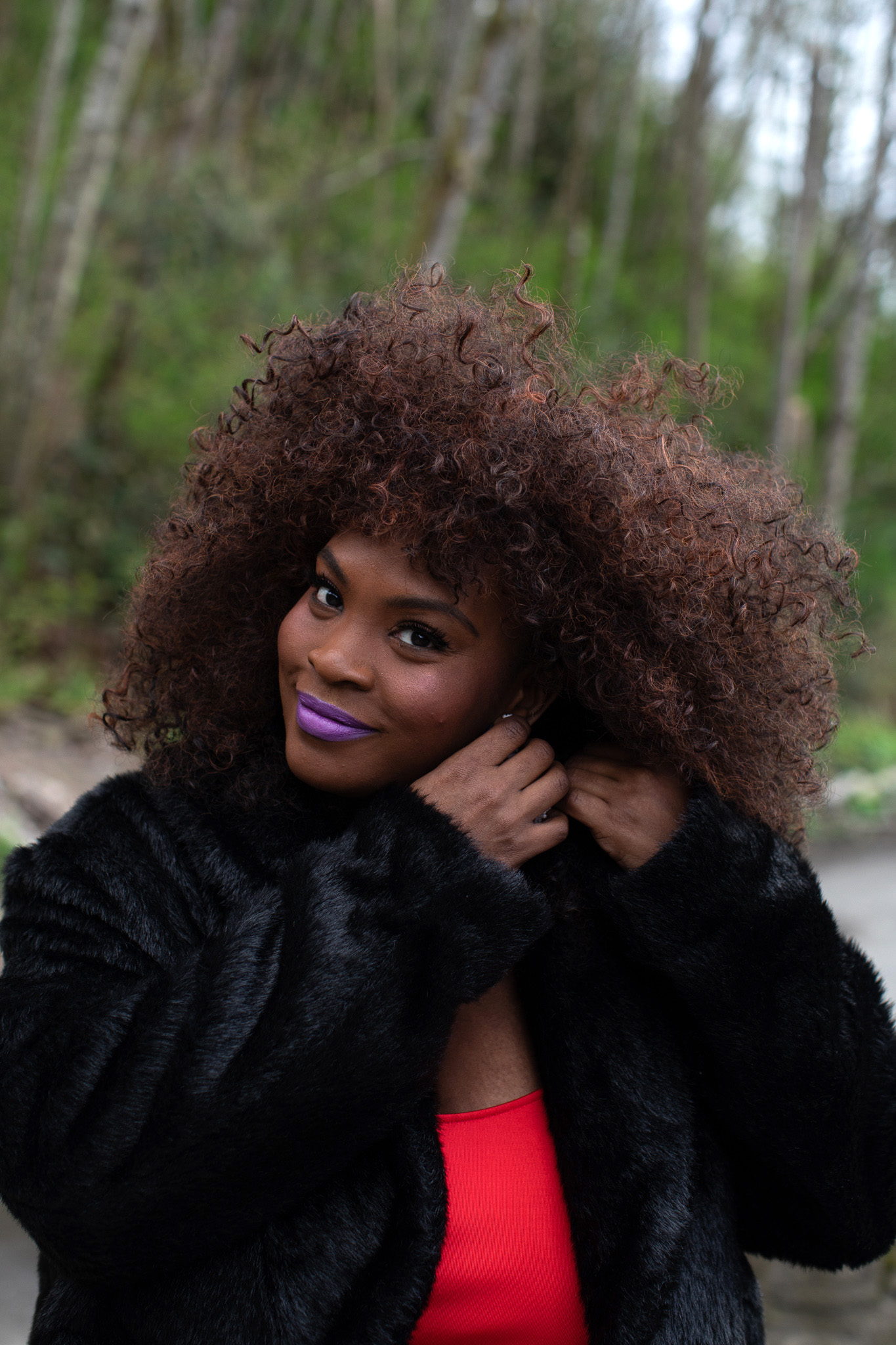 Woman with purple lipstick on green background