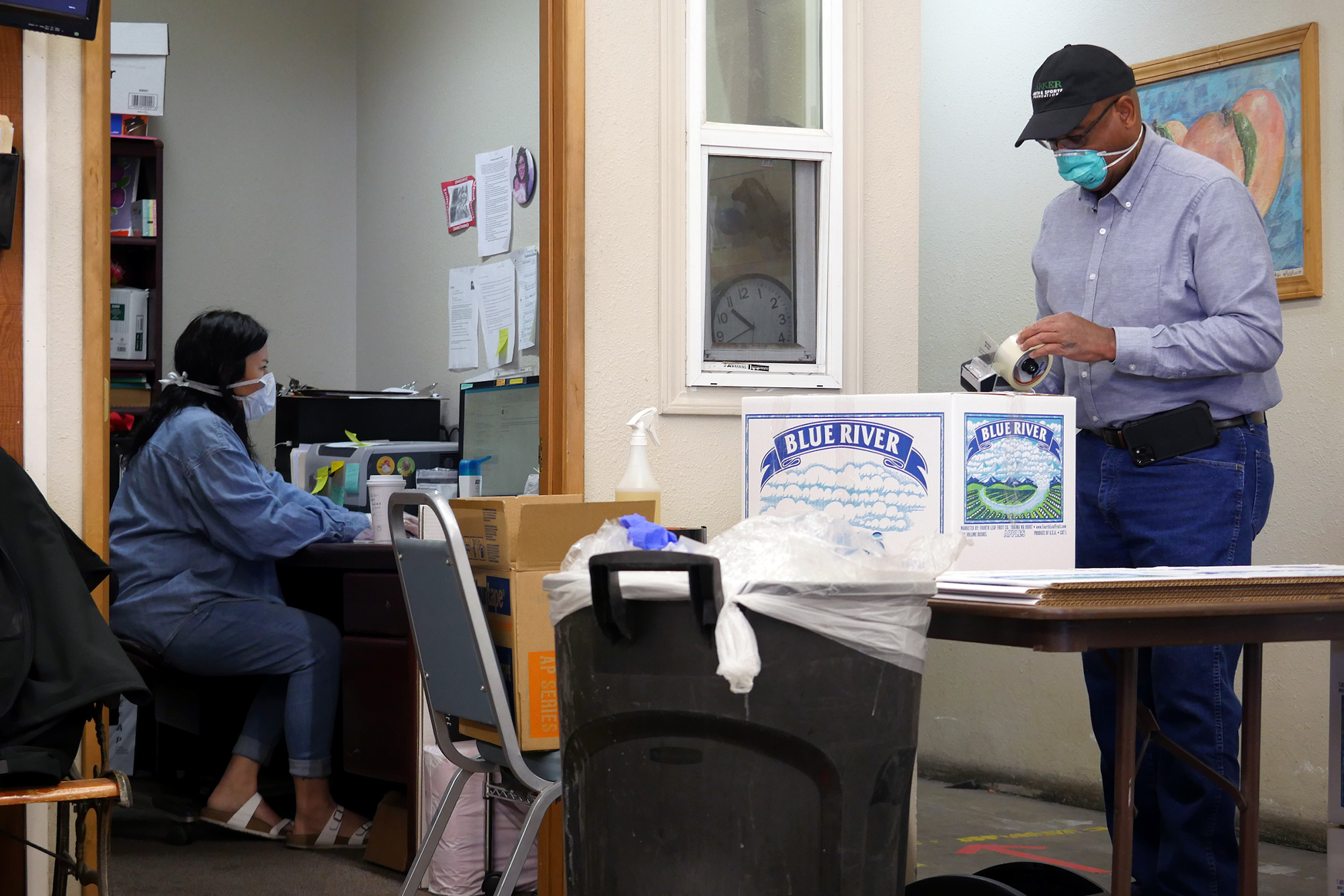 Two people work in a food bank