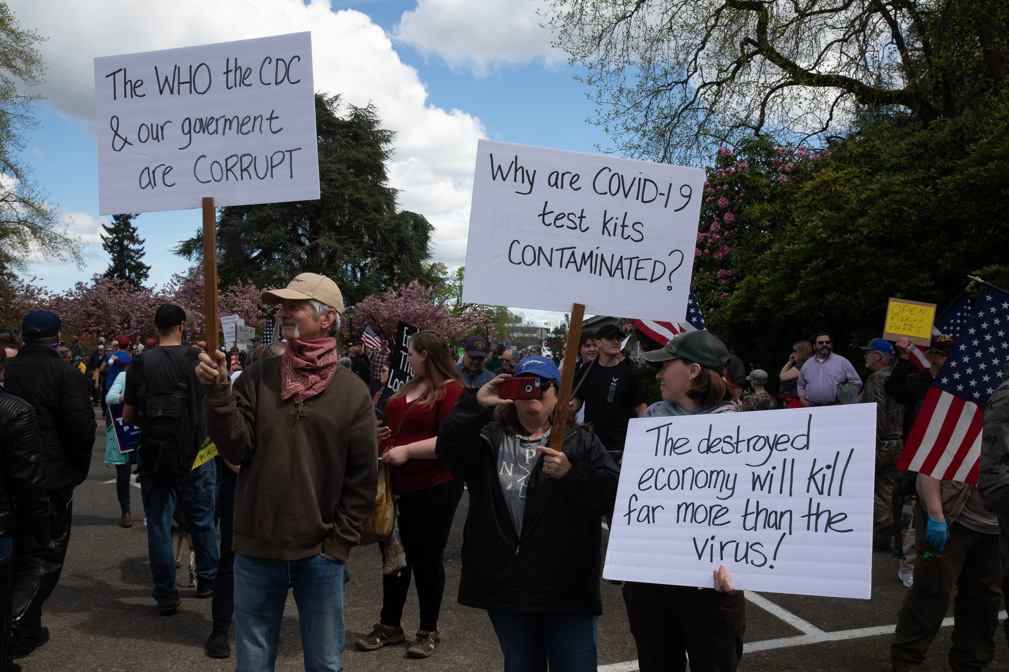 Protesters hold signs