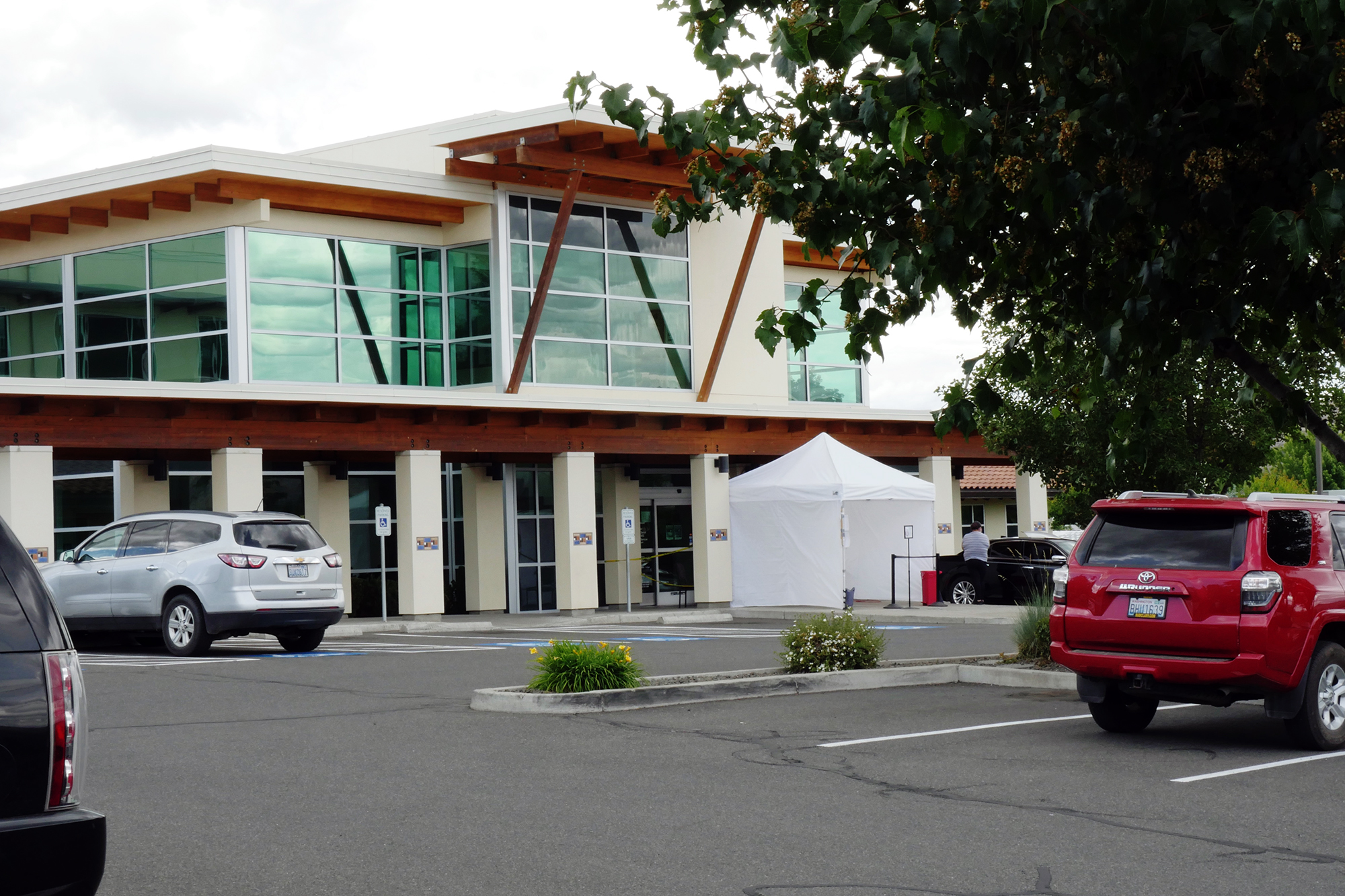 A medical clinic with a white COVID-19 testing tent 