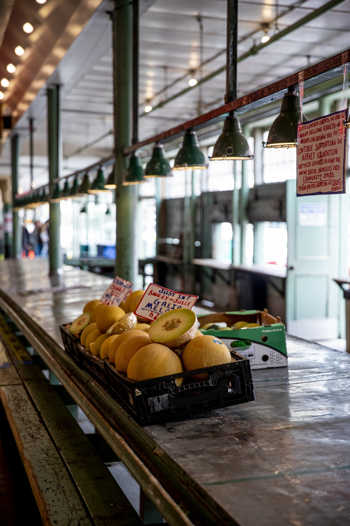 solitary box of fruit in an empty pike place arcade