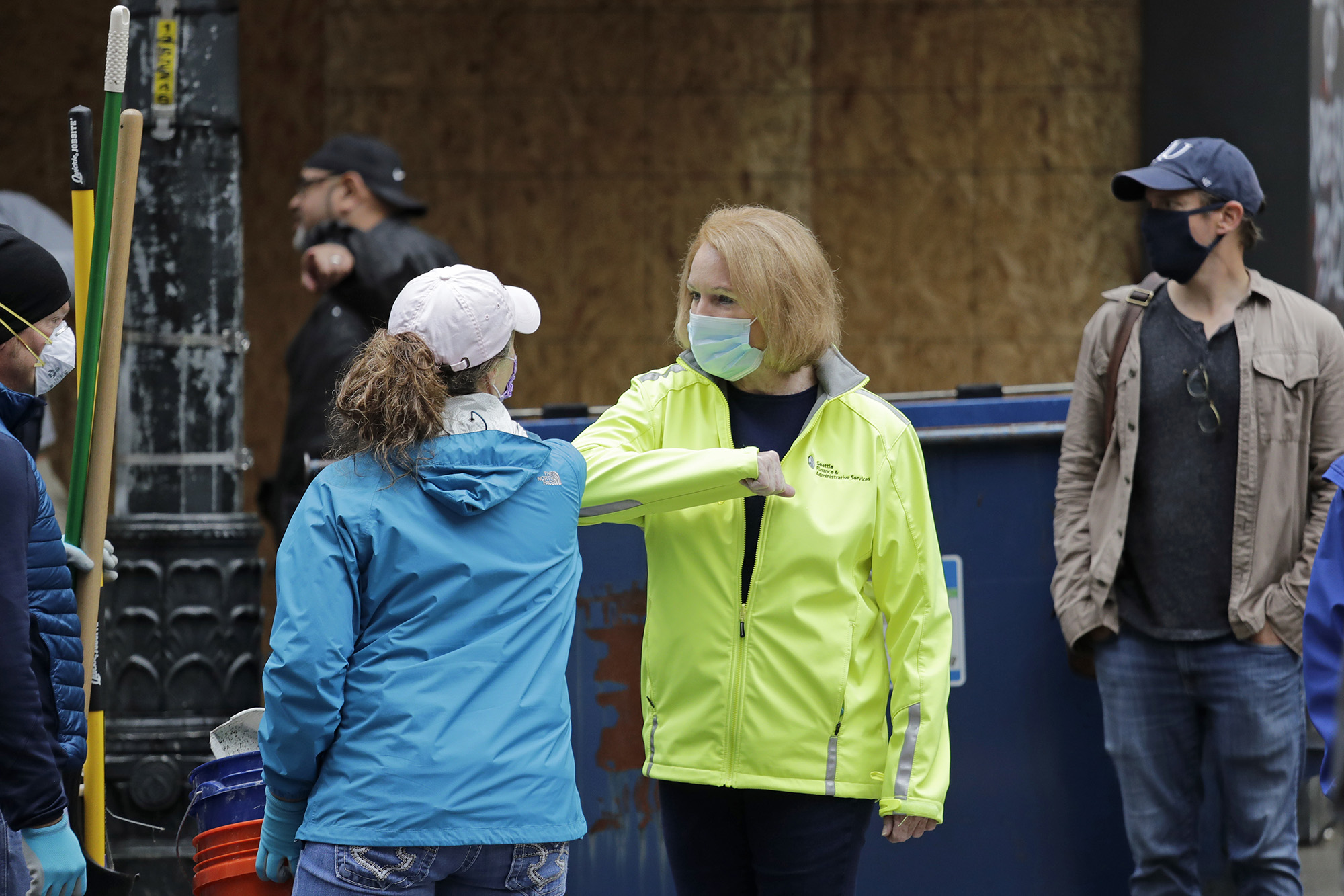 mayor durkan gives someone a forearm high-five