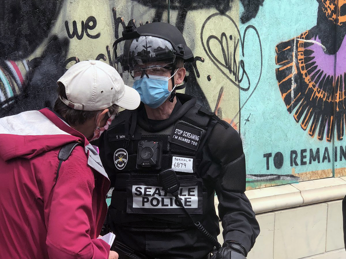 police officer with a patch affixed to his vest that reads, STOP SCREAMING, I'M AFRAID TOO