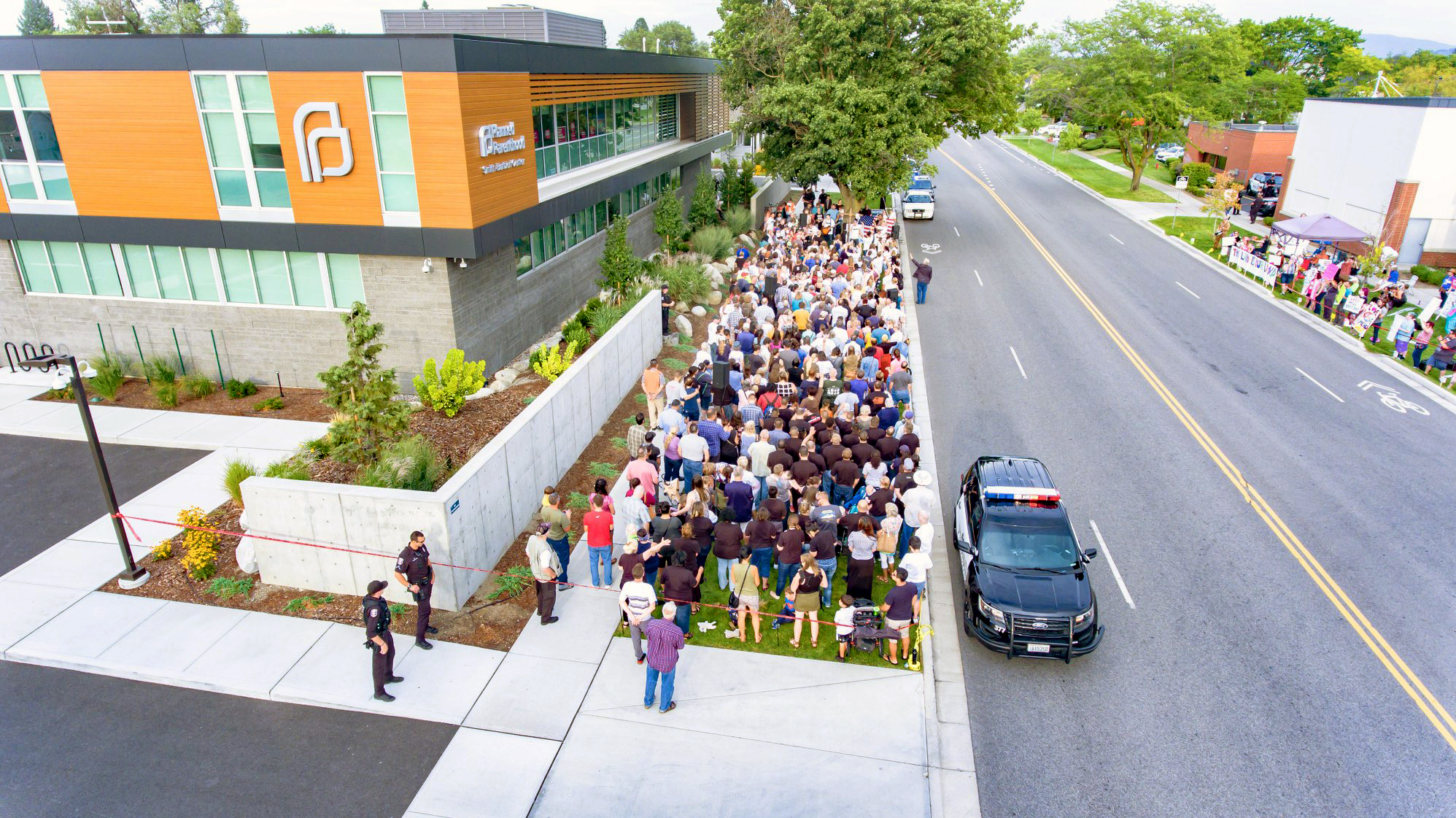 An aerial view of a group of people standing in a group outside a building