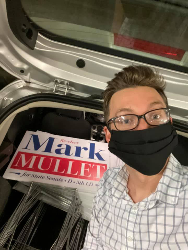 Campaign worker taking signs out of a trunk of a car