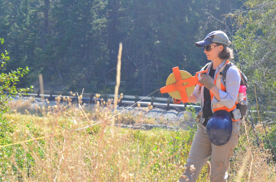 Rebecca Wassel, a biologist who helped design the project, helps mark where the creek is going to run after the culvert gets replaced. 