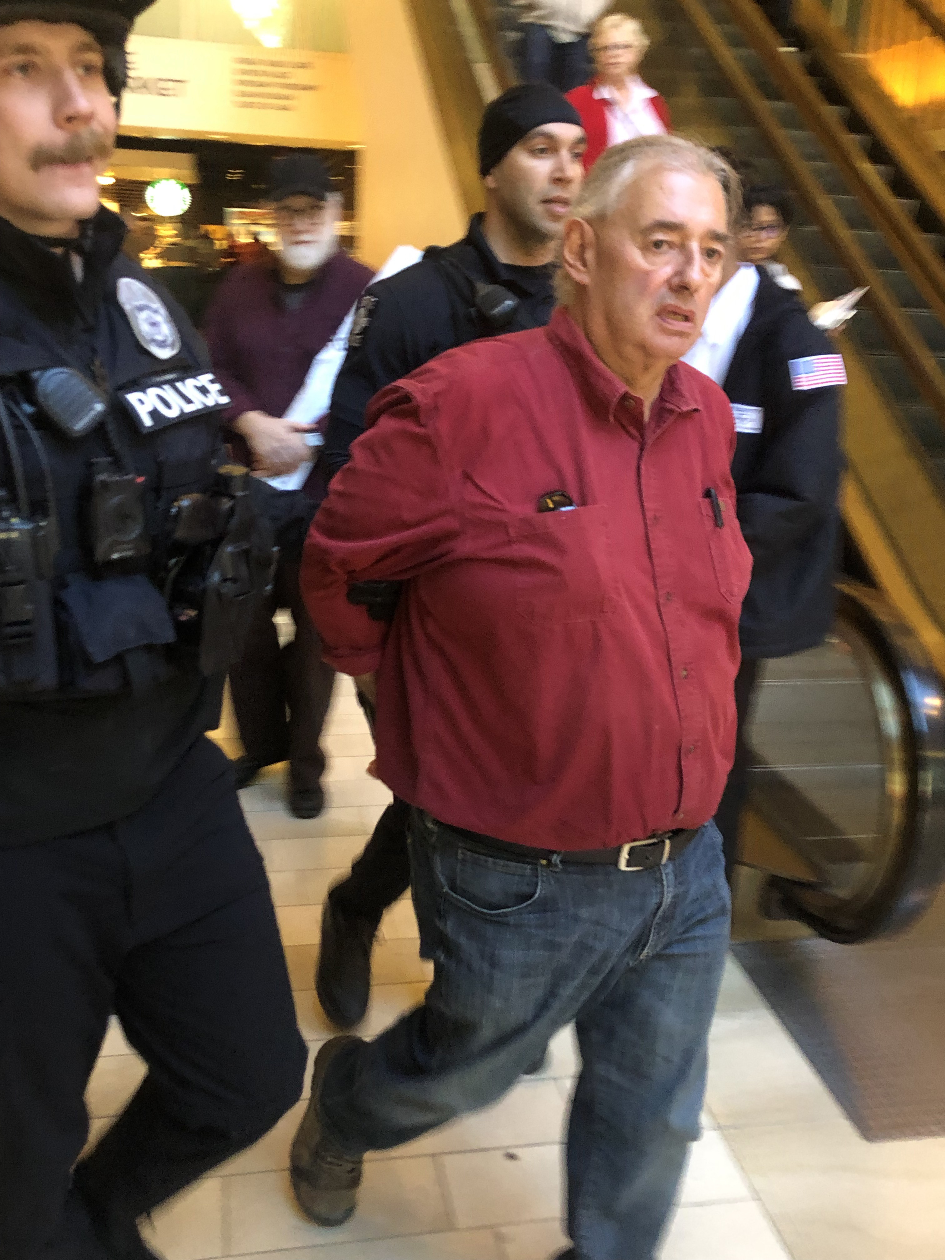 Man in handcuffs with police
