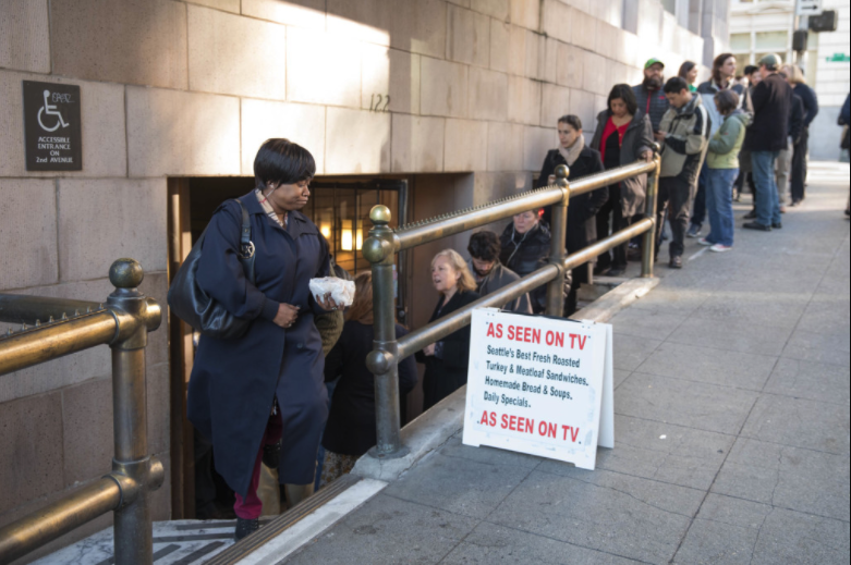 Cedrica King exits Bakeman’s Restaurant in Seattle after grabbing a roasted turkey sandwich to take back to work at her job nearby with the City of Seattle. “You better know what you want,” she’s learned in the twenty years she’s been visiting the cafeteria.