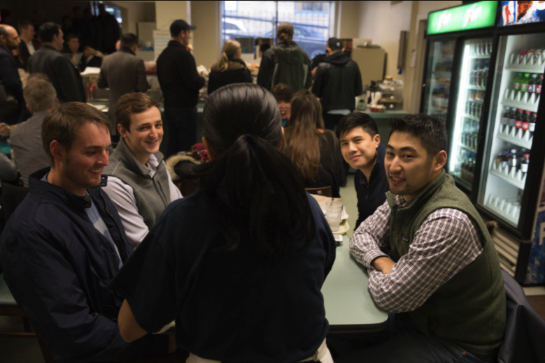 Work colleagues from Liberty Mutual’s downtown Seattle office finish eating lunch at Bakeman’s. “I’ve been coming in here for three years,” says Leonard Lee (bottom right), who checks the cafeteria’s Twitter account to find out the daily specials, like beef stroganoff. “You can’t find anything like his stroganoff or jambalaya downtown.” The first time he visited he tried to pay with a credit card and was met with a “C’mon man, What the hell is that?” — a favorite Wang tease.