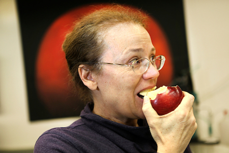 Scientist Kate Evans takes a bite of a Cosmic Crisp