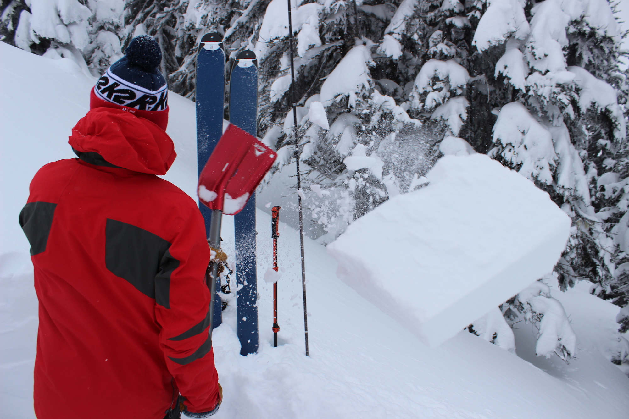 Allyn shovels away a block of snow after testing the stability.