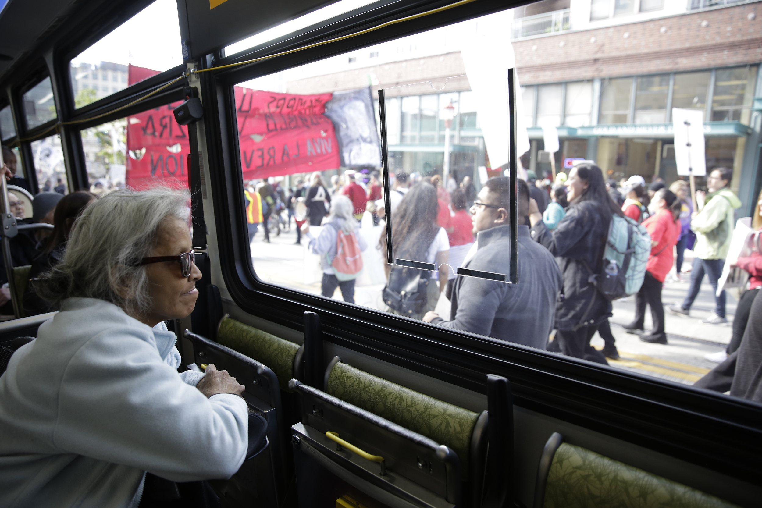 Darlene Hadley of Seattle watches from a bus stuck in traffic on South Jackson Street in the International District during the annual May Day March for Workers and Immigrant Rights in Seattle