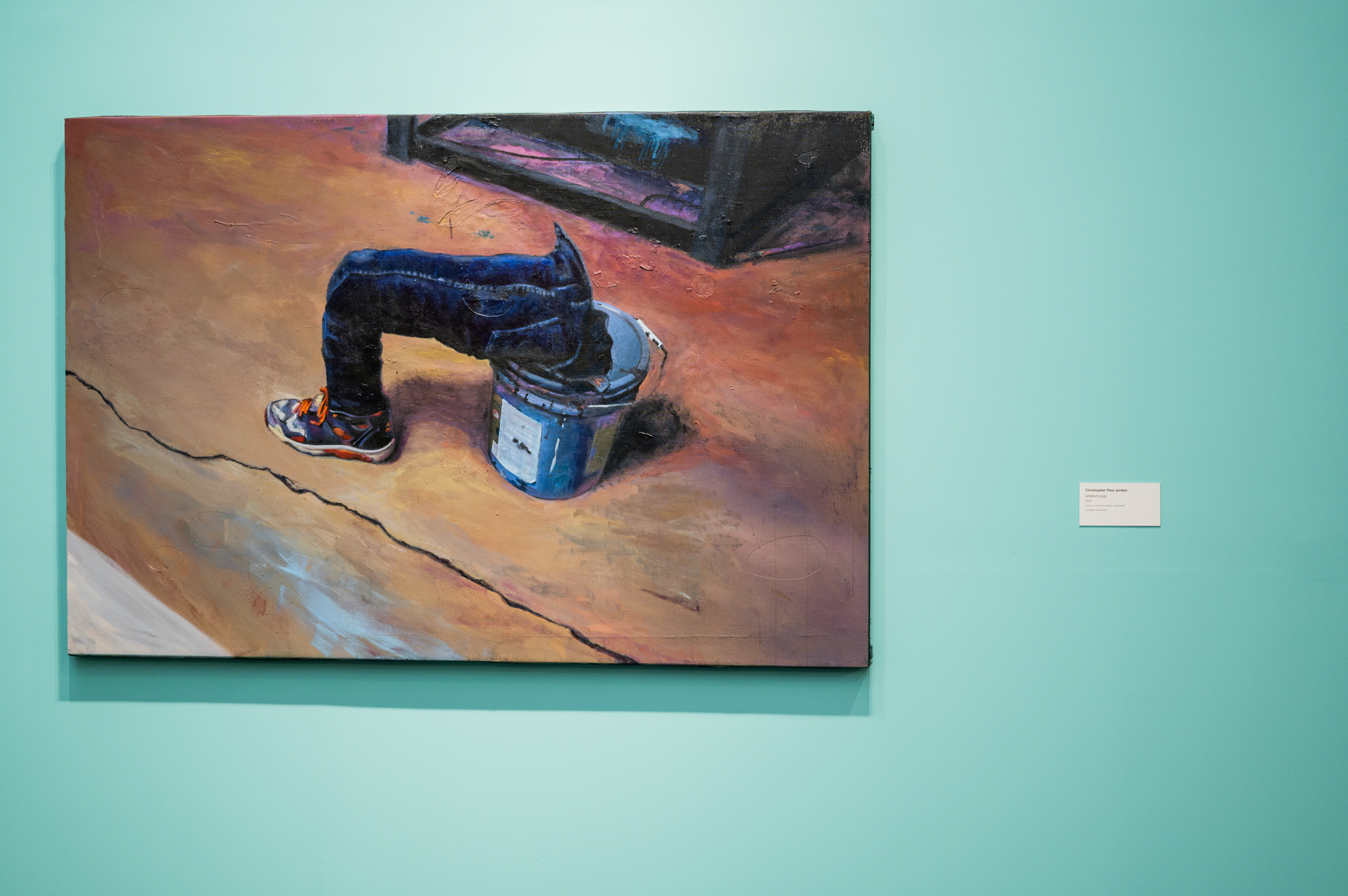 painting of a leg on a paint can