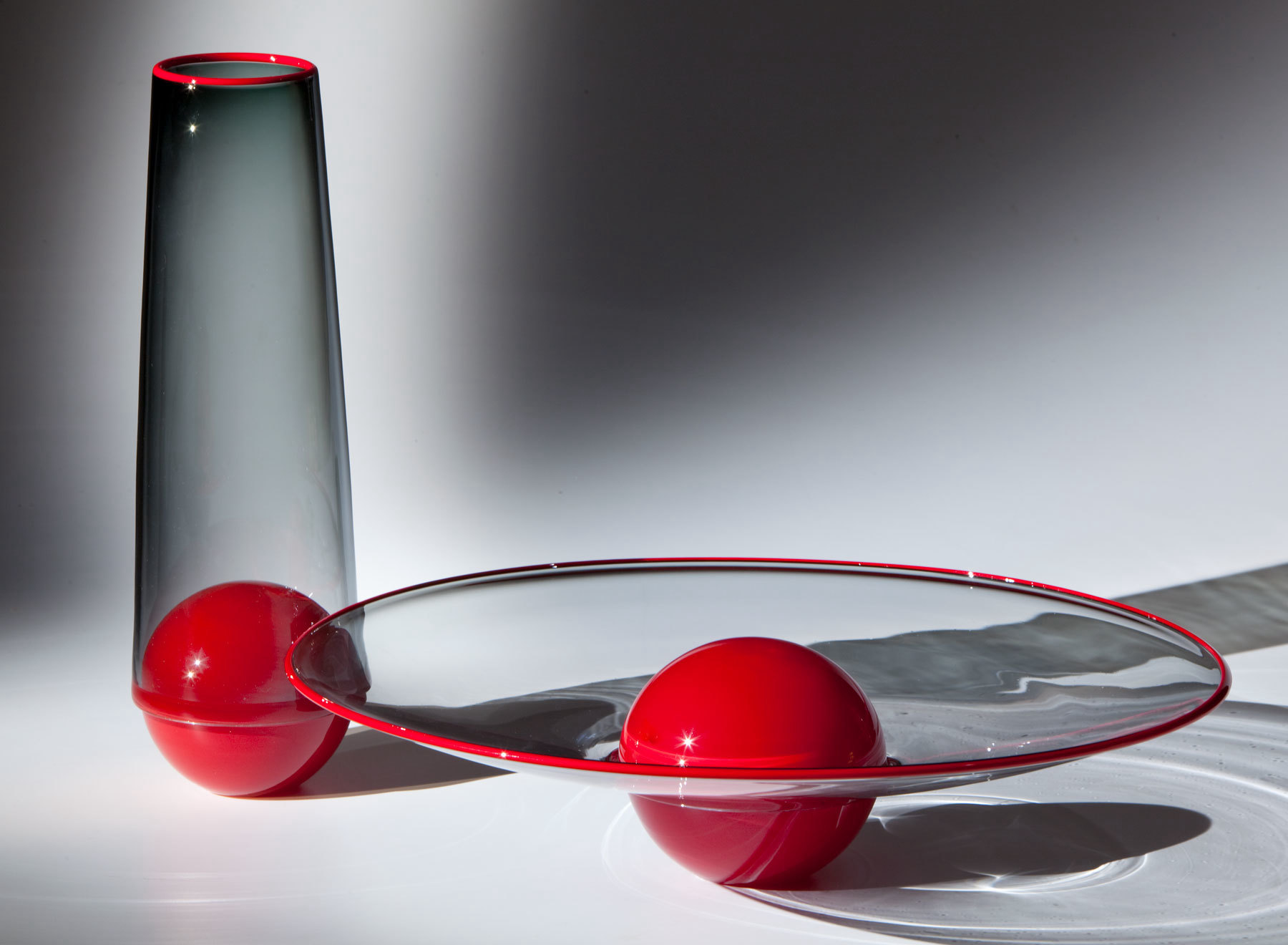 two glass vessels, red and gray