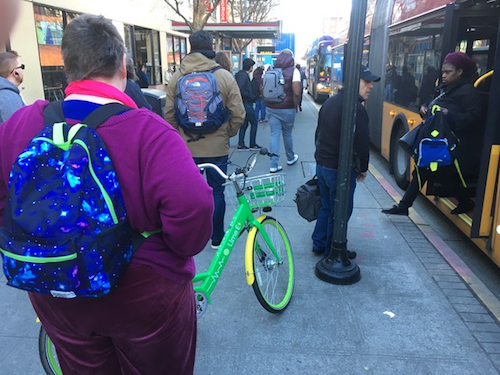 An rental bike is left in the middle of a downtown transit stop near services for the disabled/