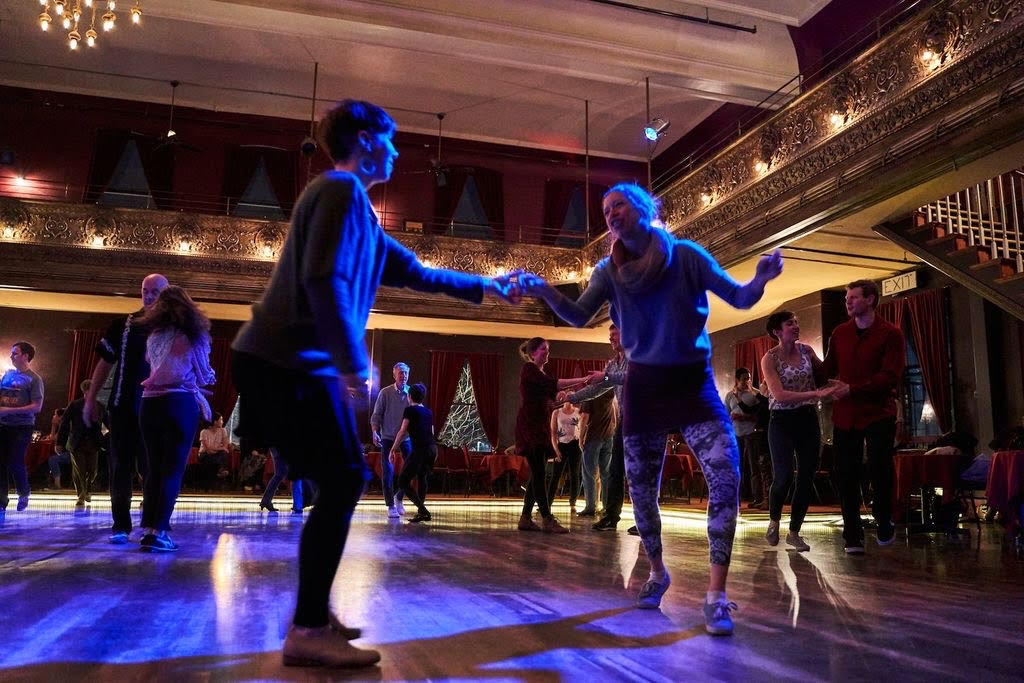 Two people swing dancing