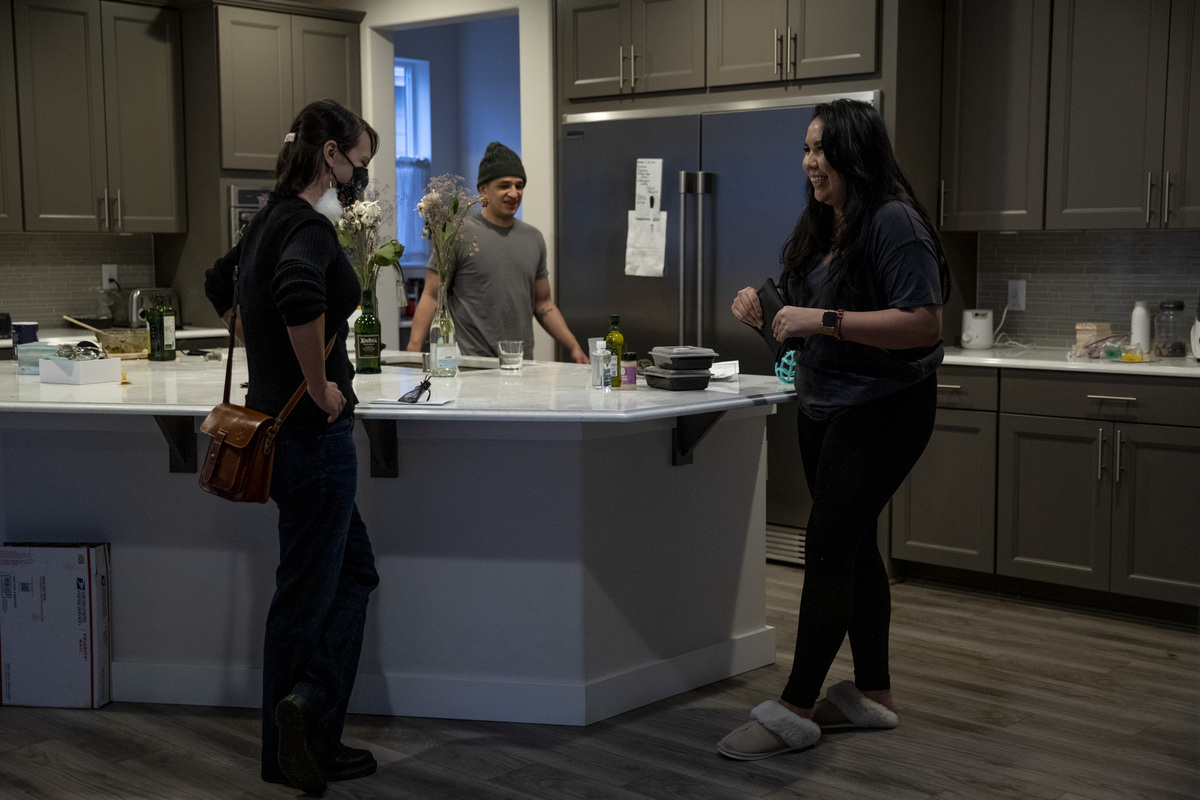 Three people in kitchen