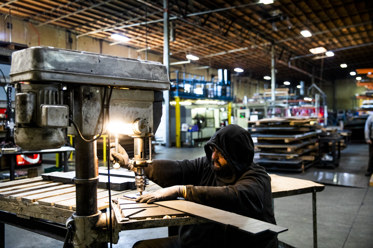 Sparks fly as a worker works on part of a ballot box.