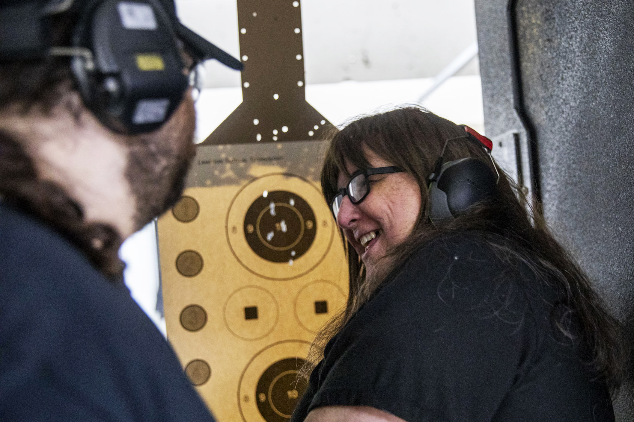 Jan Elmer, 62, laughs as she looks at her target sheet at West Coast Armory in Bellevue during a Pink Pistols range meetup on May 18, 2019. (Photo by Dorothy Edwards/Crosscut)