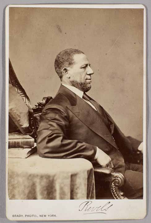 a black and white archival photo of a man sitting in profile