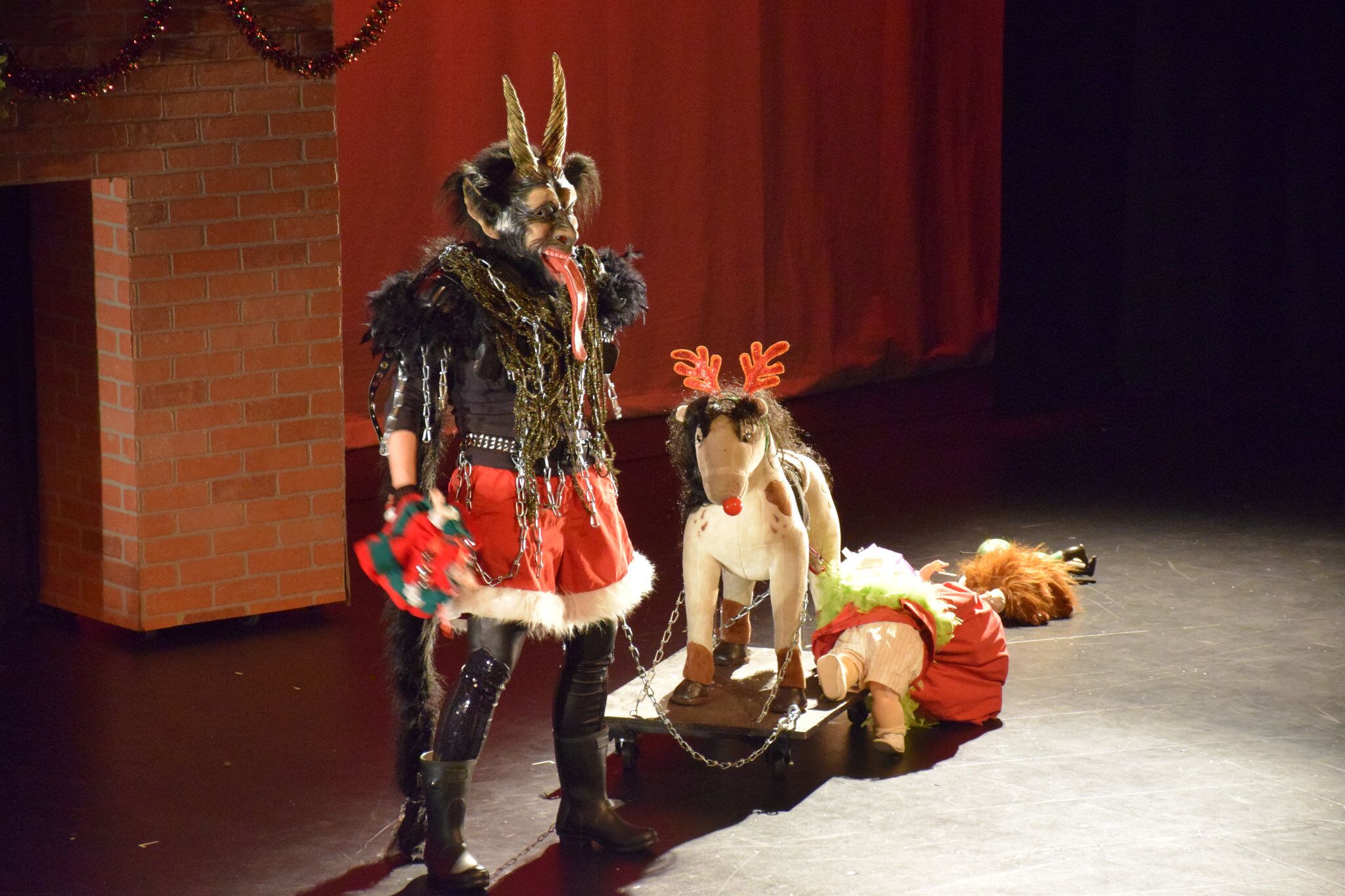 Krampus pulling dolls on a chain