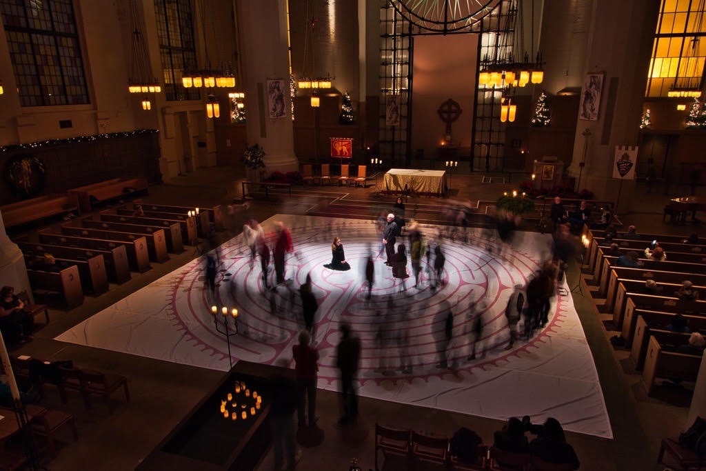 People walk along a painted labyrinth