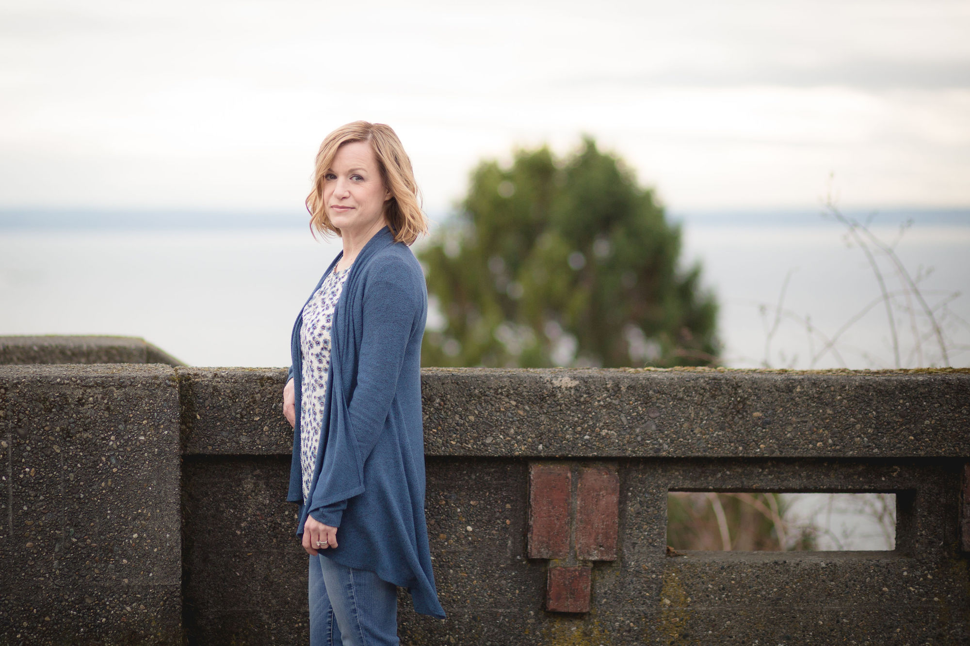 a woman standing at a bridge