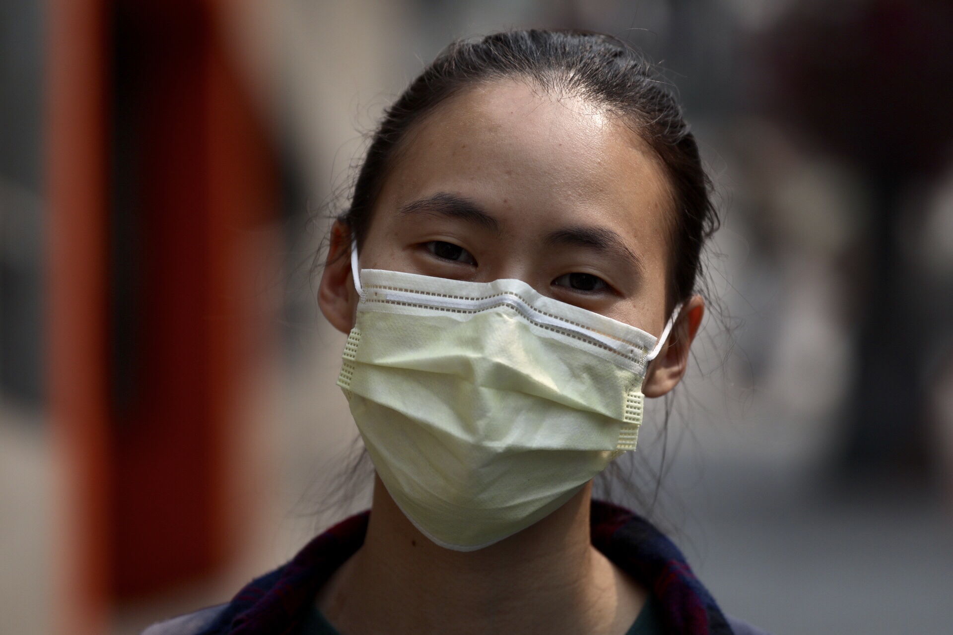 A woman wears a mask in Pioneer Square