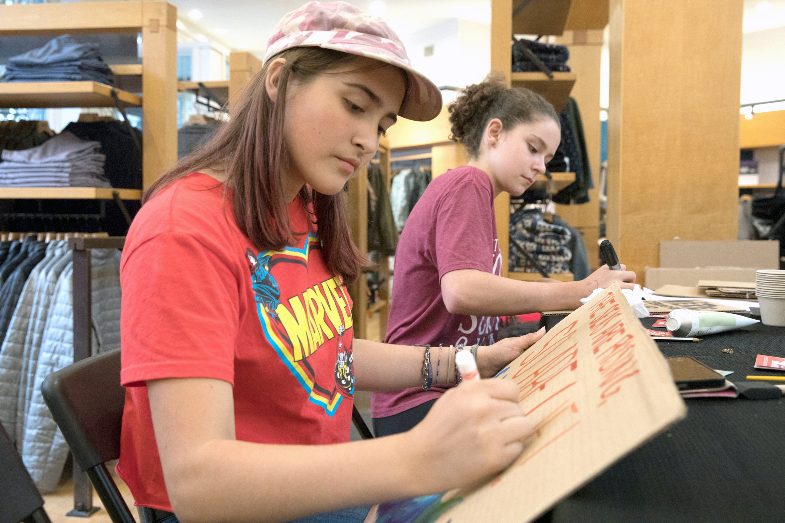 Young people prepare protest signs.