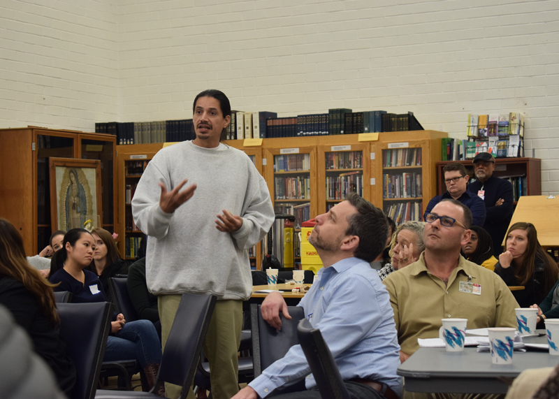 A group listening session discusses ways to help foster youth.