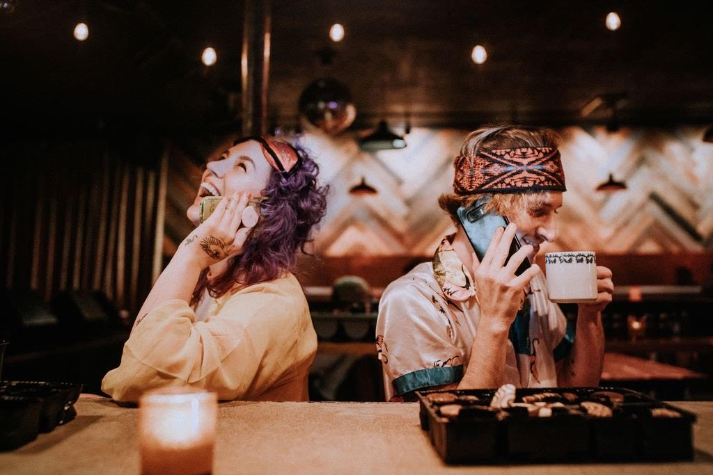 Two people at a bar in pajamas