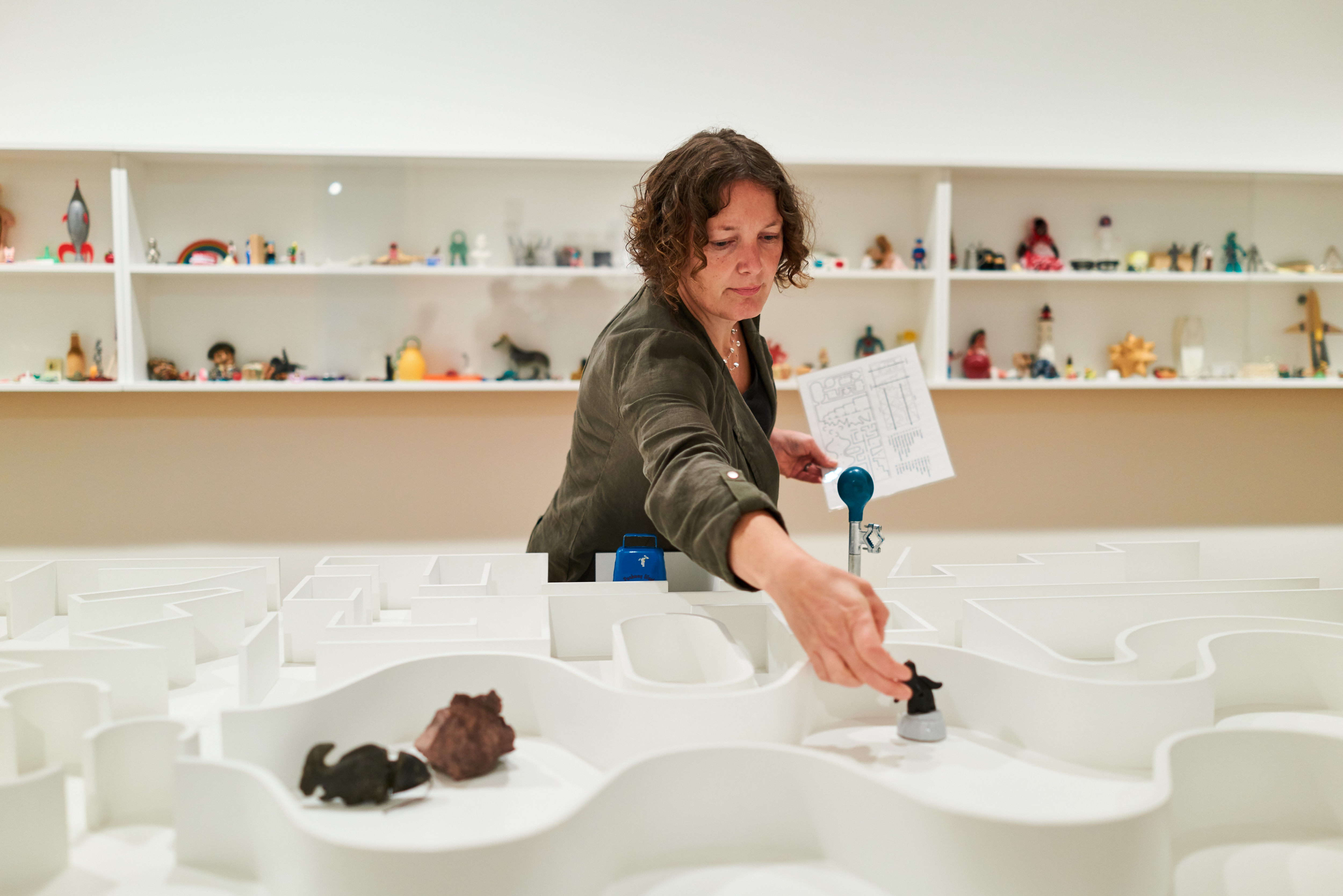 A Frye Art Museum visitor interacting with Pedro Reyes’ “The Museum of Hypothetical Lifetimes”  PHOTO CREDIT: Jonathan Vanderweit