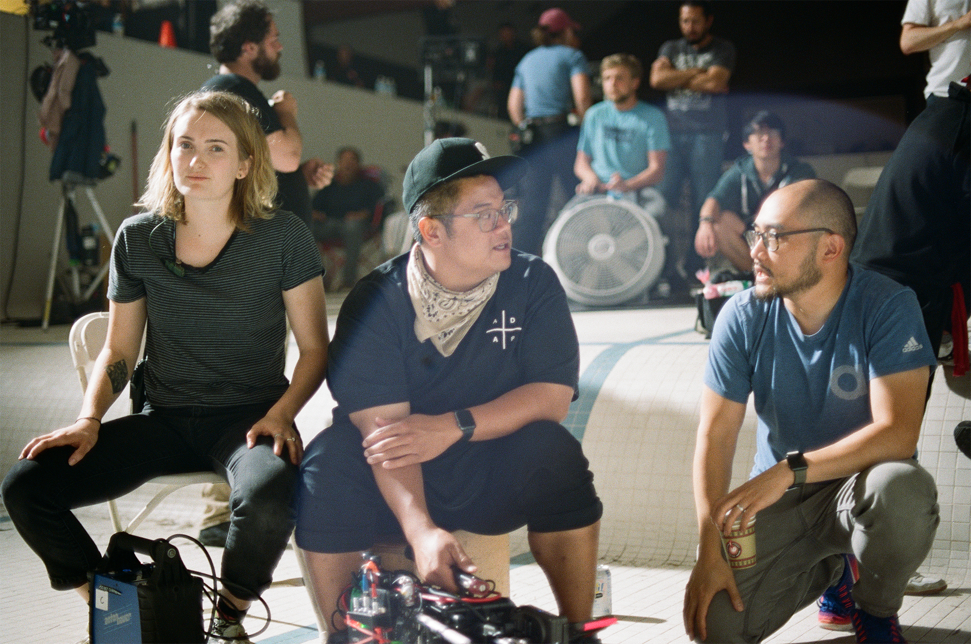 Paper Tiger crew members sit on set