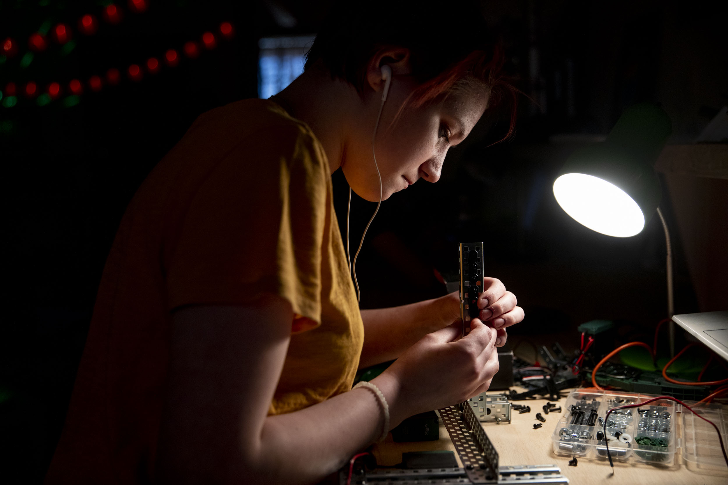 High school freshman Elly Pollock works on her robot during a Nerdy Girls meetup in Ellensburg on May 17, 2019. Pollock has been a part of Nerdy Girls since it started. Pollock says she enjoys the building part of robotics more than the coding part. "I like seeing what works and what fails and trying to improve it more and more every time," she says. (Photo by Dorothy Edwards/Crosscut)