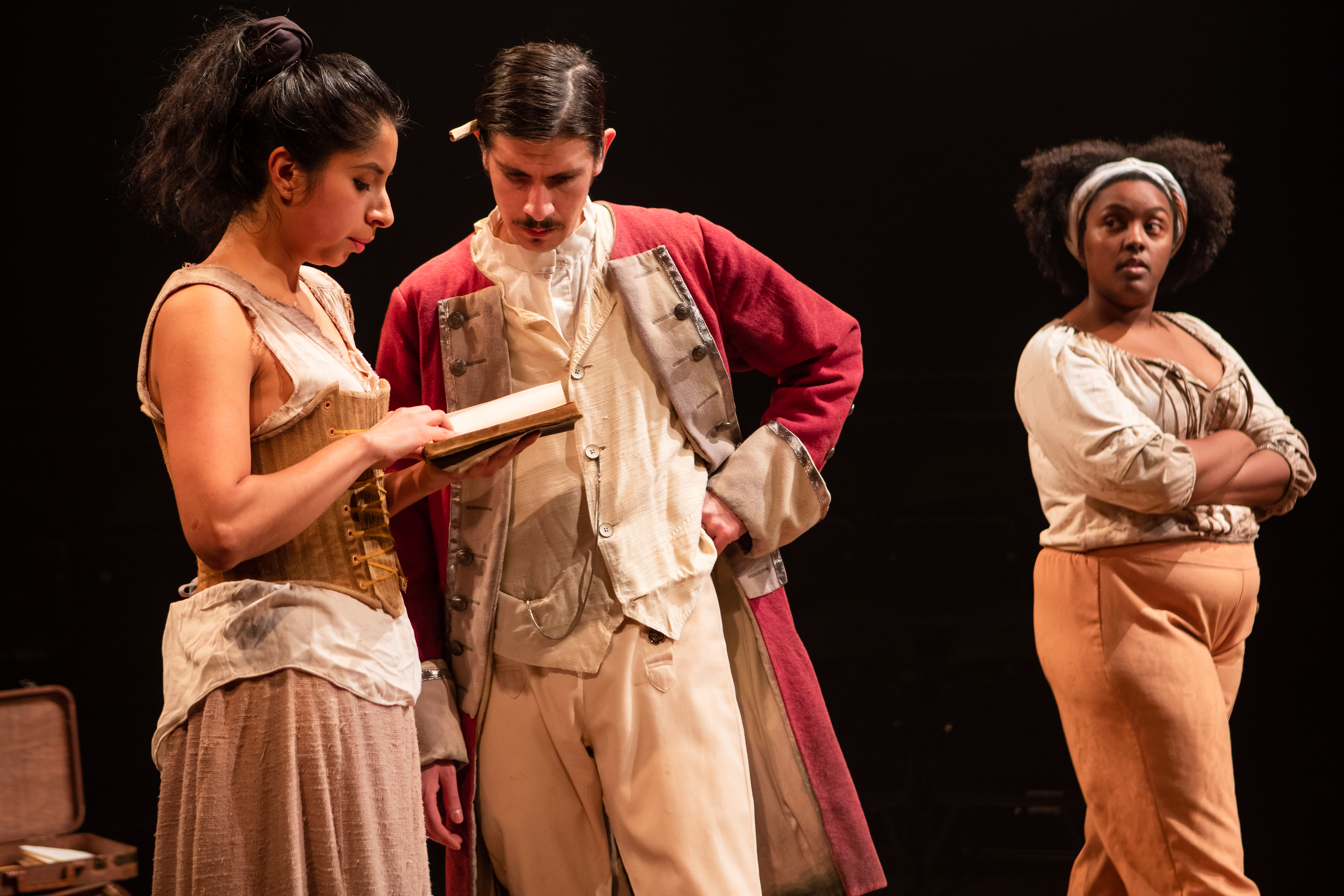 three costumed characters in a play on stage