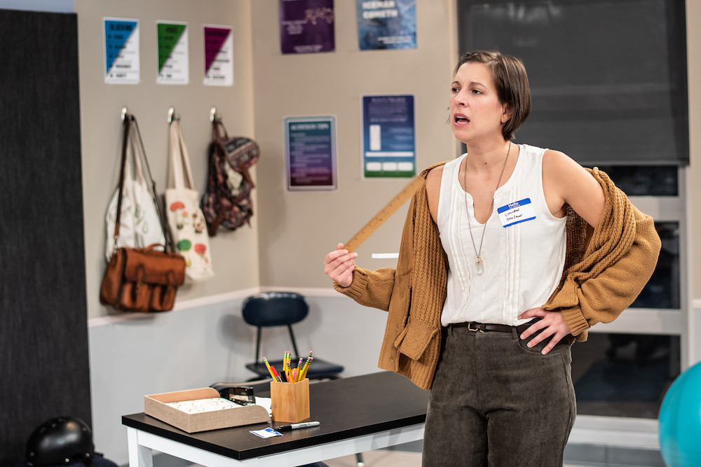 a woman in a schoolroom with a nametag