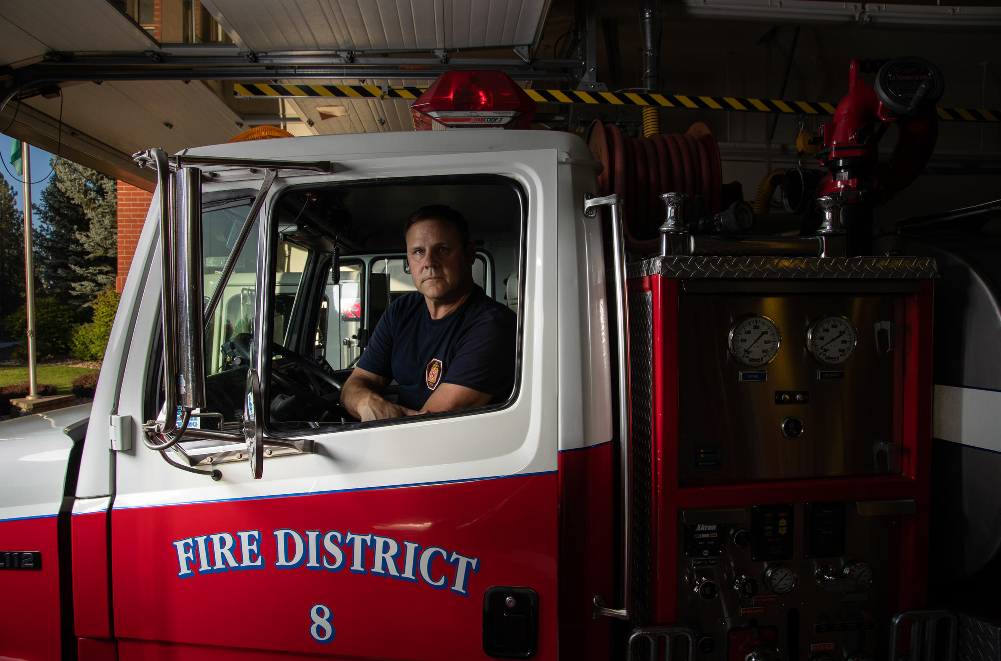 A fireman sits in a firetruck