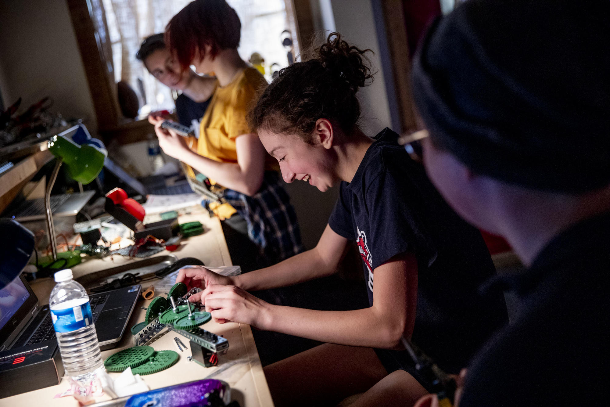 Eighth grader Maddie Bodenman laughs as she works on her robot during a Nerdy Girls meetup in Ellensburg on May 17, 2019. Nerdy Girls is an underground robot society started by sisters Parker and Greta Mayer in January 2017. (Photo by Dorothy Edwards/Crosscut)