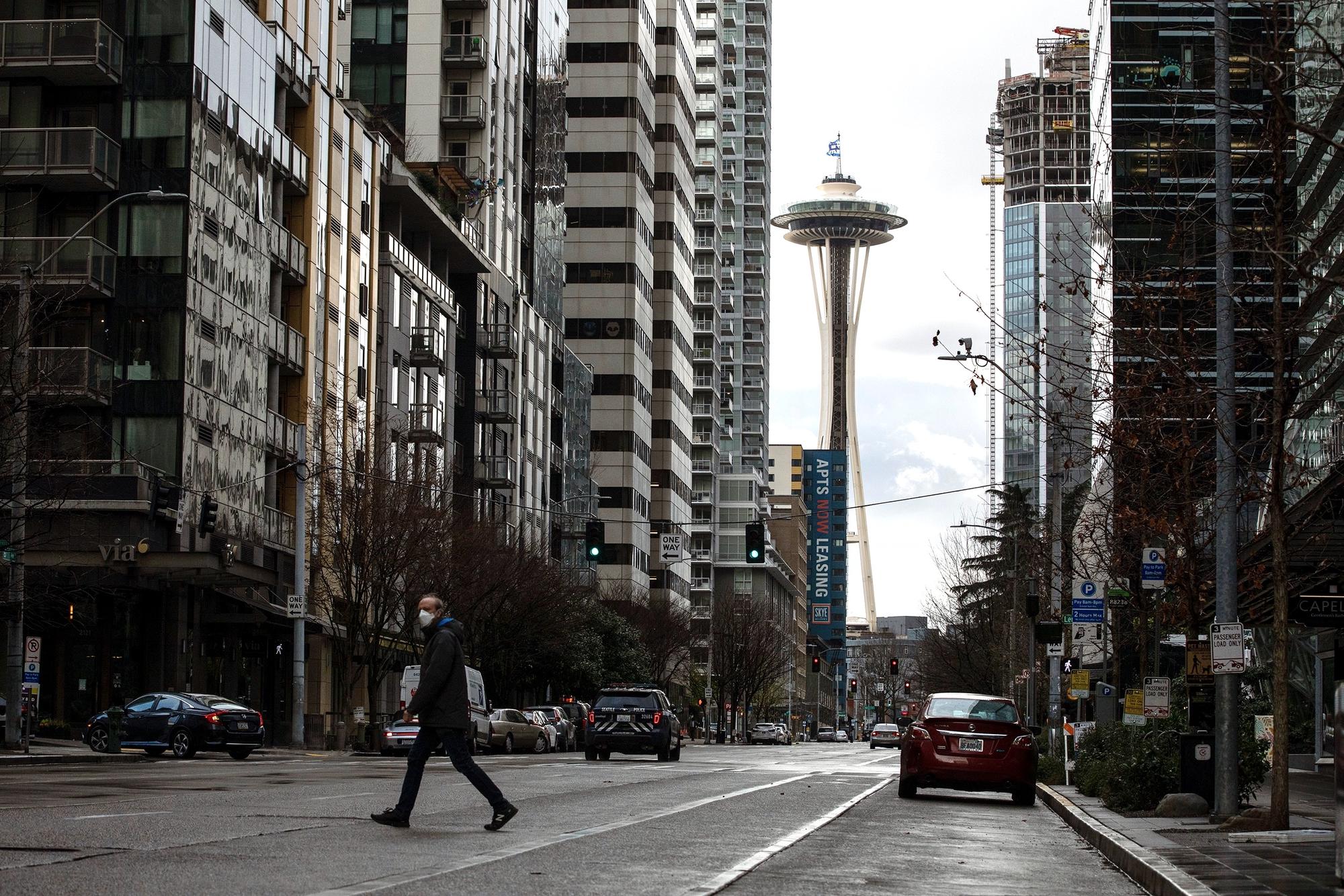 man walking across the street