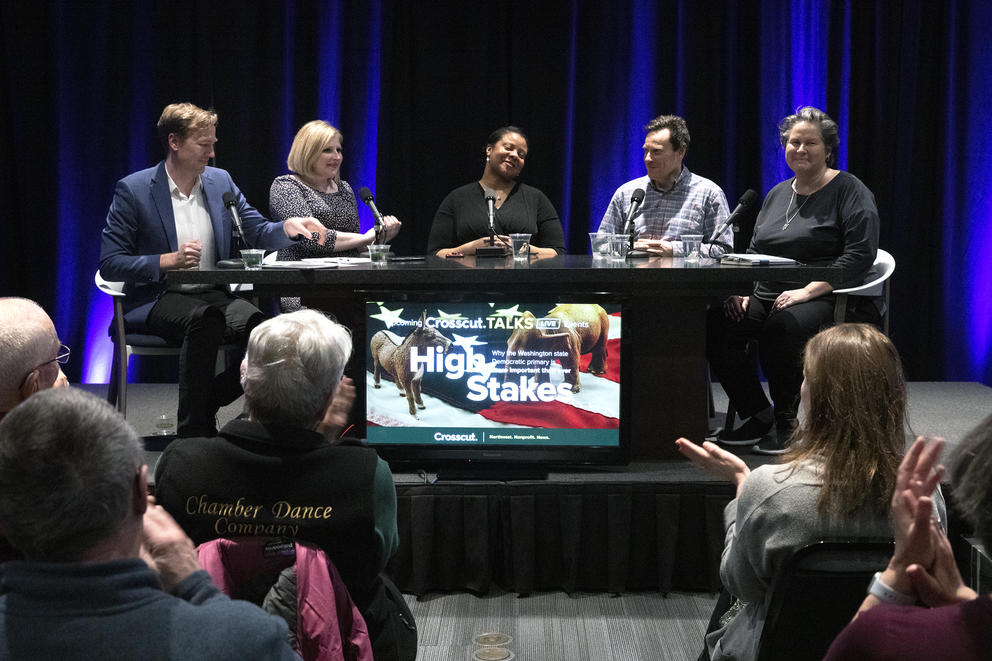 Table of panelists at a desk