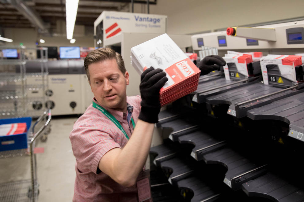 Election worker moving ballots