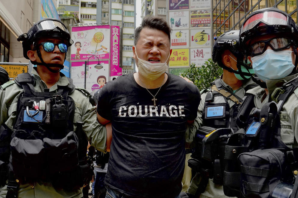 Police with handcuffed protester