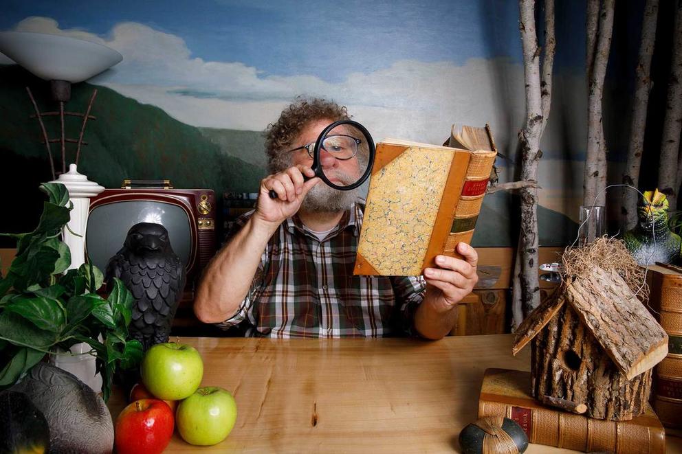 Knute Berger looking at a book