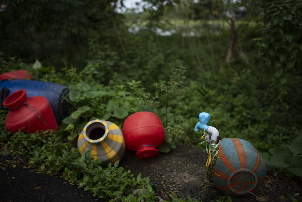 Colorful water jugs in the grass